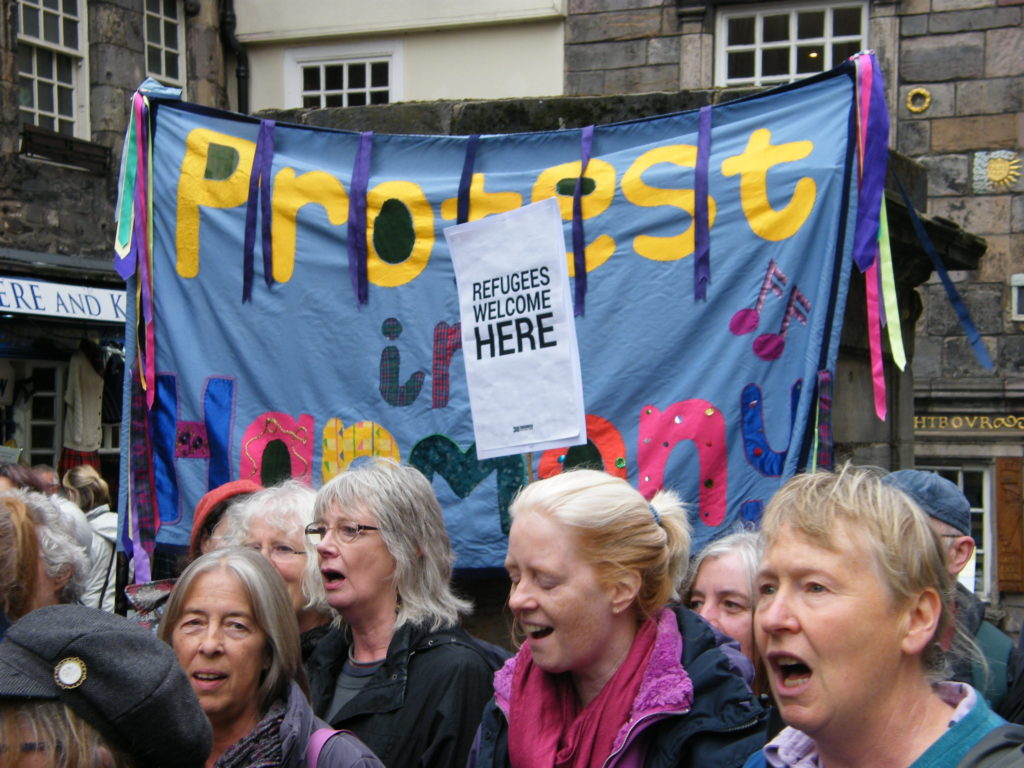 Singers standing in front of the Protest in Harmony banner