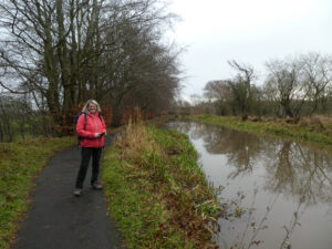 Woman standing beside the canal