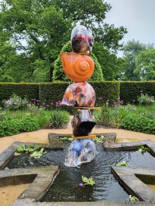 Colourful ceramic snails piled on top of each other making a water feature